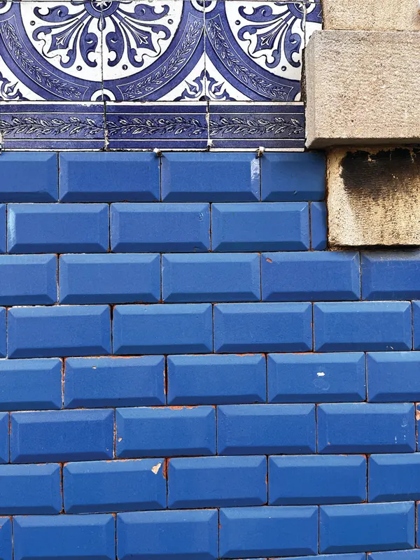 Blue glazed tiles under a decorated border