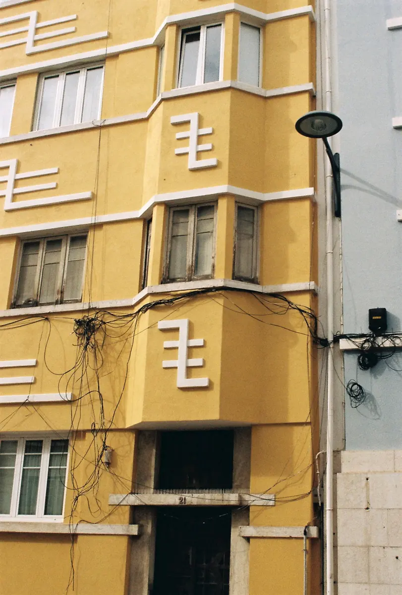 Yellow apartment building with a street lamp