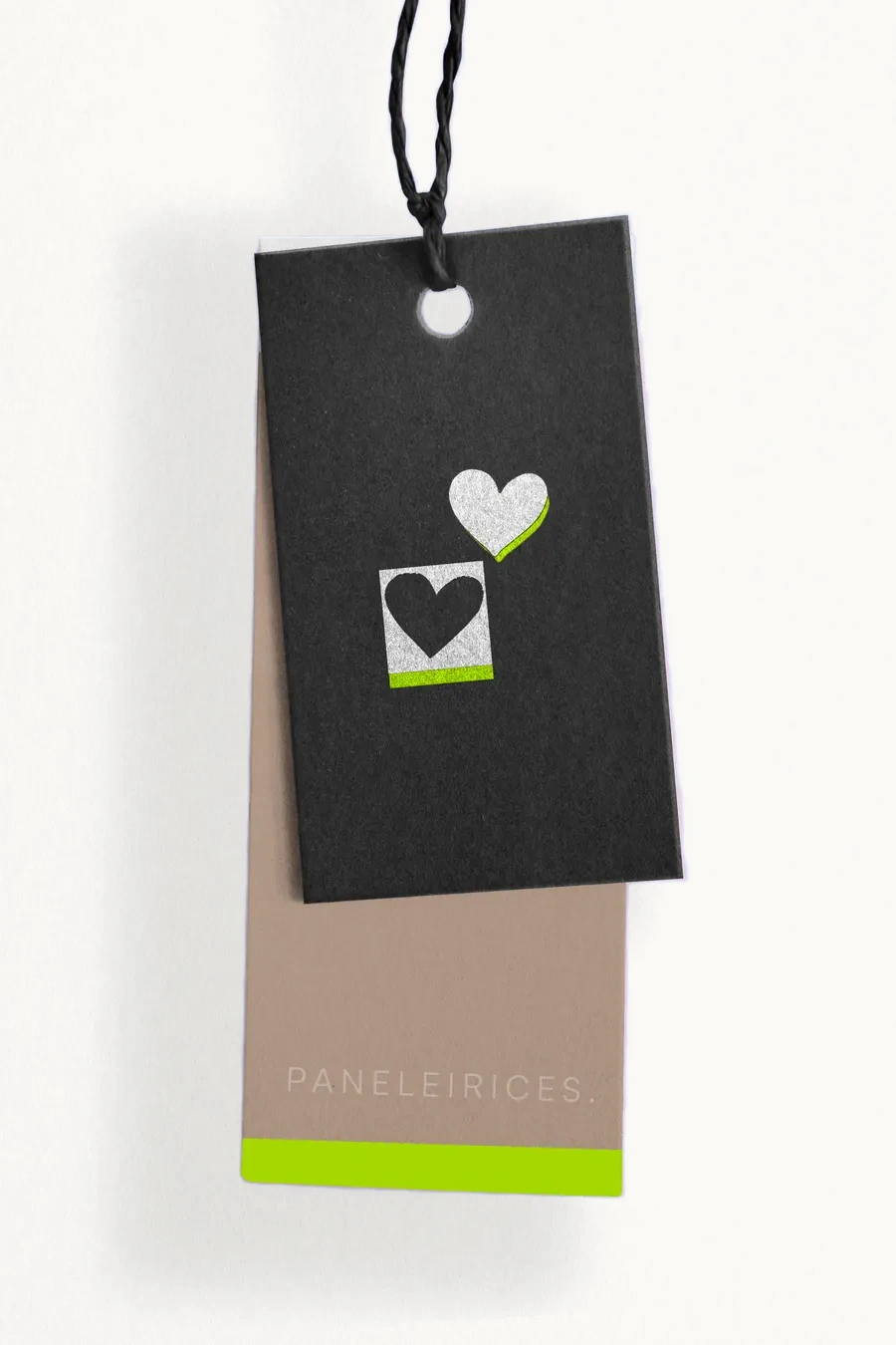 A black hang tag with a heart, over a kraft tag with a neon base