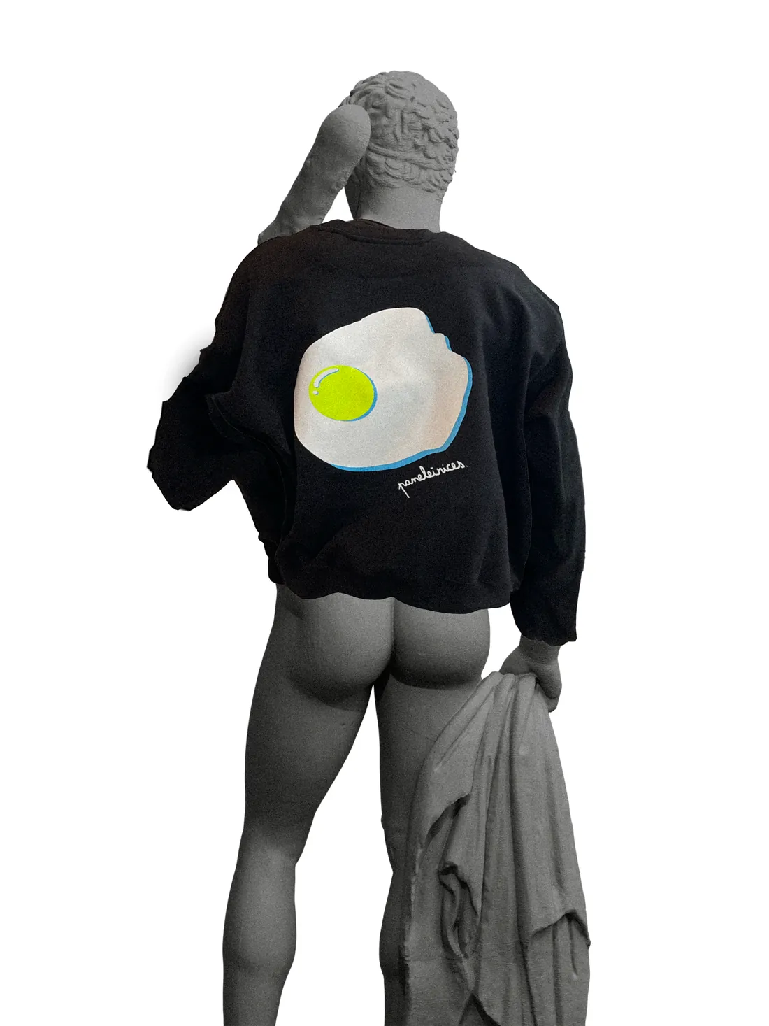 A 3D statue seen from behind, wearing a black sweater with a fried egg graphic