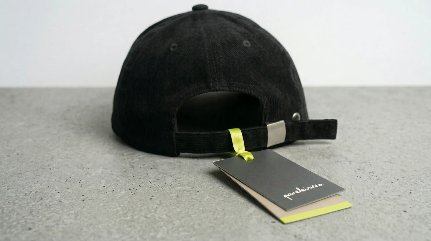 Boxes and a cap with its label on a concrete surface