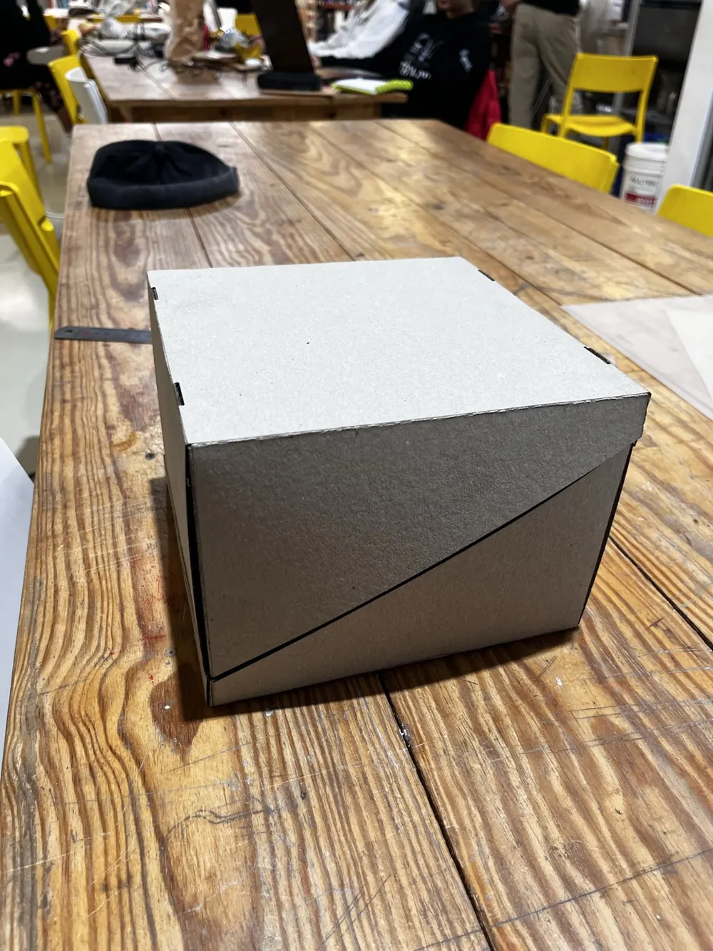 The closed box seen from the side, on a workshop table