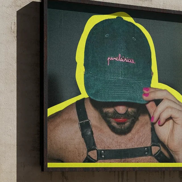 Billboard ad: a man in a harness pulls a green cap over his face, outlined in neon
