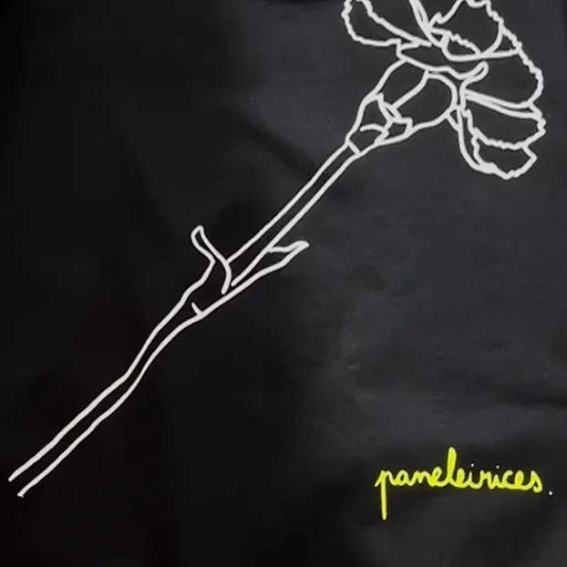 Black Paneleirices sweater with a white line-art carnation and a neon logo